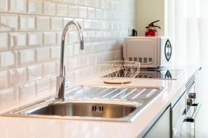 a kitchen with a sink and a microwave at VIVA Size Flats Clérigos in Porto +158 photos