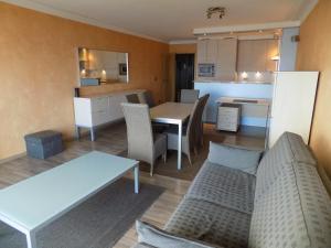 a living room and kitchen with a table and a couch at romanza 104 in Middelkerke