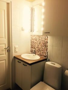 a bathroom with a sink and a toilet at Saaritupa Apartment Saariselkä in Saariselka