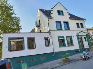 a house with a motorcycle parked in front of it at Pension Hoffmann in Wuppertal
