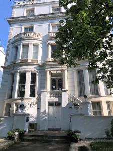 a white house with a white door and stairs at Ravna Gora in London
