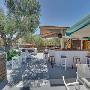 a patio with a bar with chairs and tables at Valentina Apartments in Gouves