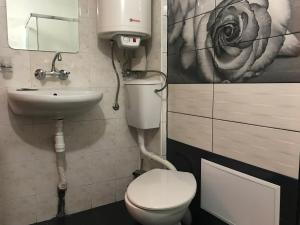 a bathroom with a toilet and a sink at Day and Night in Veliko Tŭrnovo