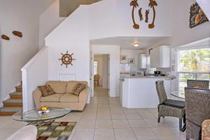 a living room and kitchen with a couch and a table at Lovely Sea Dreams Villa with Private Beach and Deck! in Banksville