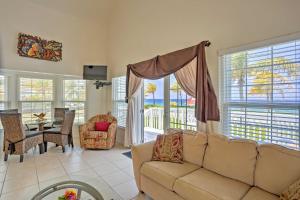 a living room with a couch and a view of the ocean at Lovely Sea Dreams Villa with Private Beach and Deck! in Banksville