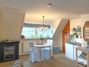 a kitchen with a table and a stove in a room at Congenial Apartment in Wei enbrunn with Garden and Barbecue in Weißenbrunn