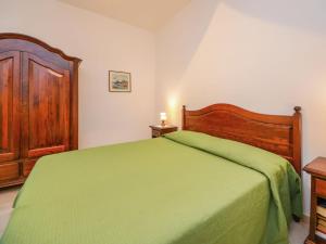 a bedroom with a green bed and a wooden cabinet at Boutique Mansion in Sorrento with Picturesque View in Sorrento