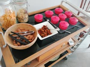 a table with a cart filled with different types of food at Poggio del Gallo in Chiaramonte Gulfi