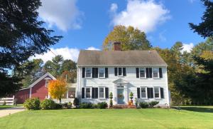 a white house with a red house at Silvershell Inn in Marion