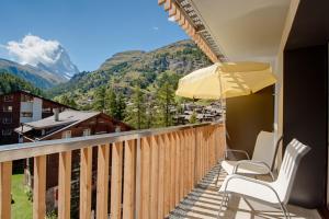 
a view from a balcony of a balcony overlooking a city at Hotel Bristol in Zermatt
