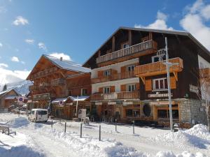 a large building with snow in front of it at cellier 6 in Les Deux Alpes
