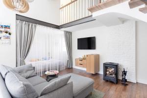 a living room with a couch and a fireplace at 3 Bedroom Apartment 24h self check in, free parking, Ac, fireplace in Vilnius