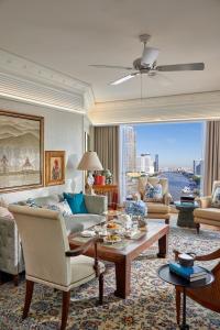 a living room with a couch and a table at Mandarin Oriental Bangkok - SHA Extra Plus in Bangkok