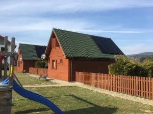 a house with solar panels on the roof at Domki Krótki Szpic in Istebna