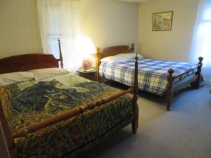 a bedroom with two beds with a dragon on them at Fishing Creek Lodge at Ricketts in Benton