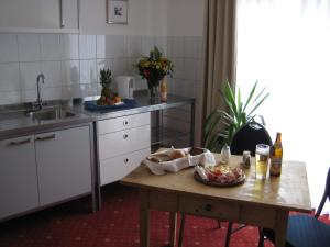 a kitchen with a table with a bowl of food on it at Komfort Apartmenthaus Haslbach FGZ in Regensburg