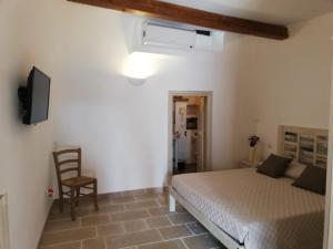 Postel nebo postele na pokoji v ubytování Trulli Resort Monte Pasubio Trulli bbalberobellocom