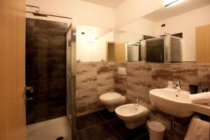 a bathroom with a sink and a toilet and a shower at Hotel La Meridiana in Settimo Torinese +6 photos