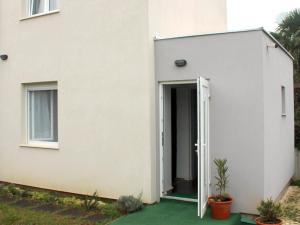 a white house with an open door at Apartment Studio Fuart in Štinjan