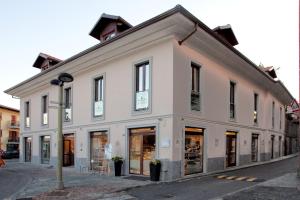 a large white building on a city street at Hotel La Meridiana in Settimo Torinese