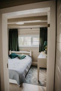 a bedroom with a bed and a window at 5 stories in Inkartai