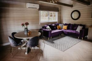 a living room with a purple couch and a table at 5 stories in Inkartai