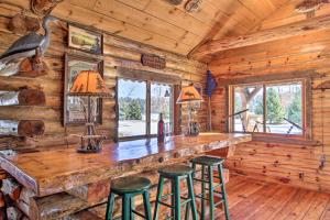 a bar in a log cabin with stools at Cabin on Private Island Less Than 6 Mi to Sand Valley Golf in New Rome