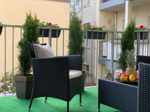 a balcony with two chairs and a table with fruit on it at Niki Apartment in Vienna