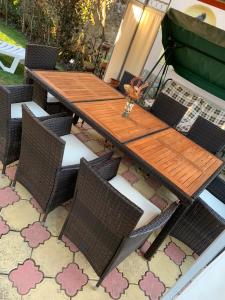 a wooden table and chairs on a patio at Sunny House Madjare Guest House in Madzhare