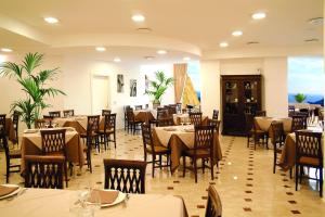 a dining room with tables and chairs in a restaurant at Resort Borgo San Rocco in Savoca 