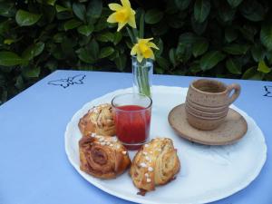 a plate of pastries and a cup of tea on a table at kotas-Esprit Nordique in Balaives-et-Butz
