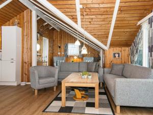 a living room with a couch and a table at 6 person holiday home in Toftlund in Arrild