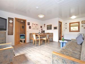 a living room with a table and a couch at Holiday home with terrace in Stadlern