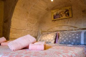 a bedroom with a bed with pink towels on it at Il trullo del Mirto in Selva di Fasano