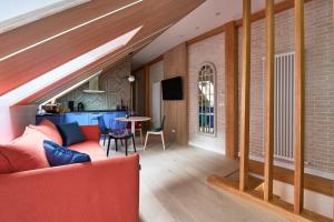 a living room with a red couch and a table at Dream Boutique Apartments in Rīga