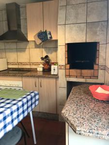 a kitchen with a table and a counter top at Casa Da Estela in Carrapateira