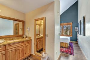a bathroom with a double sink and a bedroom at Mountain Lodge at Telluride in Telluride