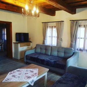a living room with a couch and a tv at Drevenica Raj in Bystrička