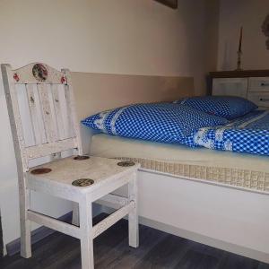 a bedroom with a chair and a bed and a chair istg at Drevenica Raj in Bystrička