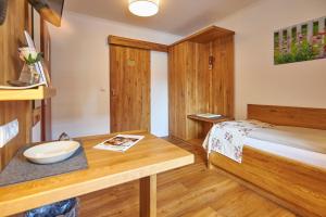 a small room with a bed and a sink at Flair Landhotel Strengliner Mühle in Pronstorf