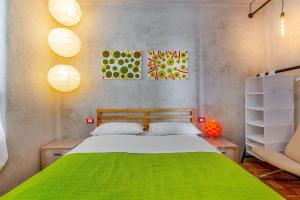 a bedroom with a green bed and a chair at Villa Orange, small house in a pine forest in Kostrena
