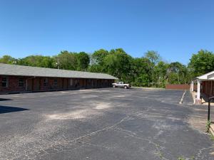 an empty parking lot in front of a building at Budget Inn Madill in Madill