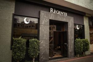 a facade of a store with a sign on it at Regente Hotel in Pato Branco