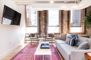 a living room with a couch and a tv at 506 Lofts in Nashville +70 photos