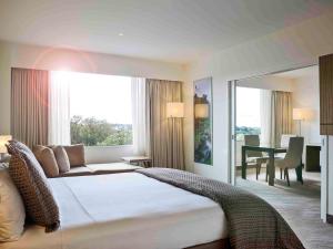 Postel nebo postele na pokoji v ubytování Novotel Auckland Ellerslie
