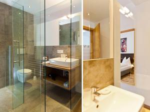 a bathroom with a sink and a glass shower at Casa Bellanova in Nauders