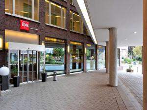 a store front of a brick building with glass doors at ibis Hamburg Alsterring in Hamburg