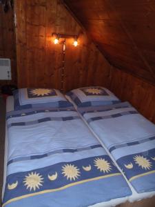 a group of three beds in a room at Penzion Mikeš in Pec pod Sněžkou