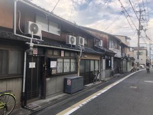 a building on a street in an asian city at Kyoto Traditional Machiya House in Kyoto