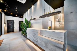 a lobby with a reception desk in a building at South Vandeco Hotel in Busan